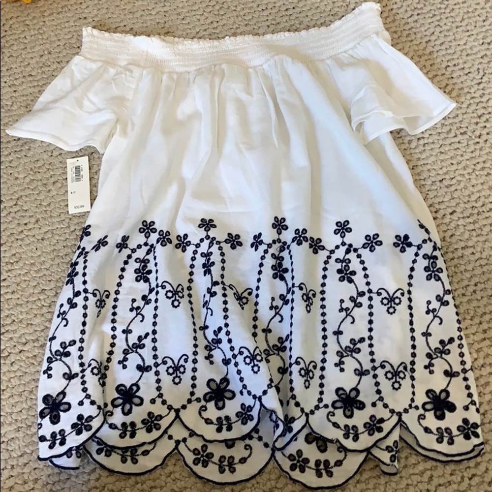 White off the shoulder shirt with flower details